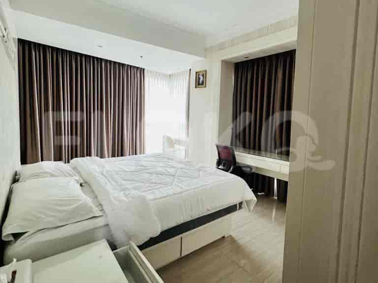 Bedroom with a desk, bed, and curtains.