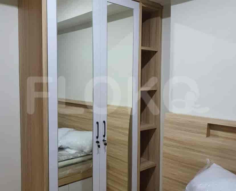 A second view of a bedroom, focused on the bed.