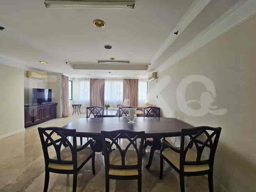 Dining area with a large table and multiple chairs.