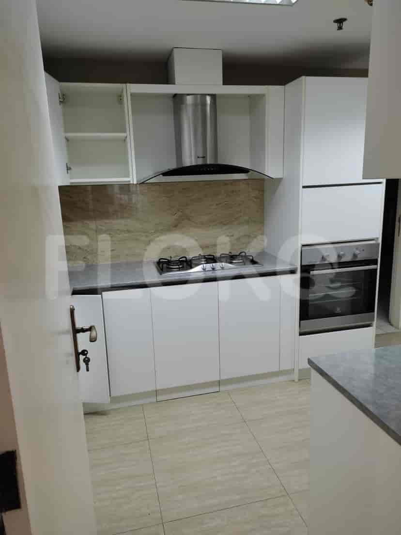 Modern kitchen with white cabinets and stainless steel appliances.