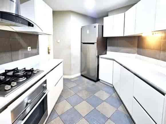 Modern kitchen with white cabinets, stainless steel appliances, and a gas stove.