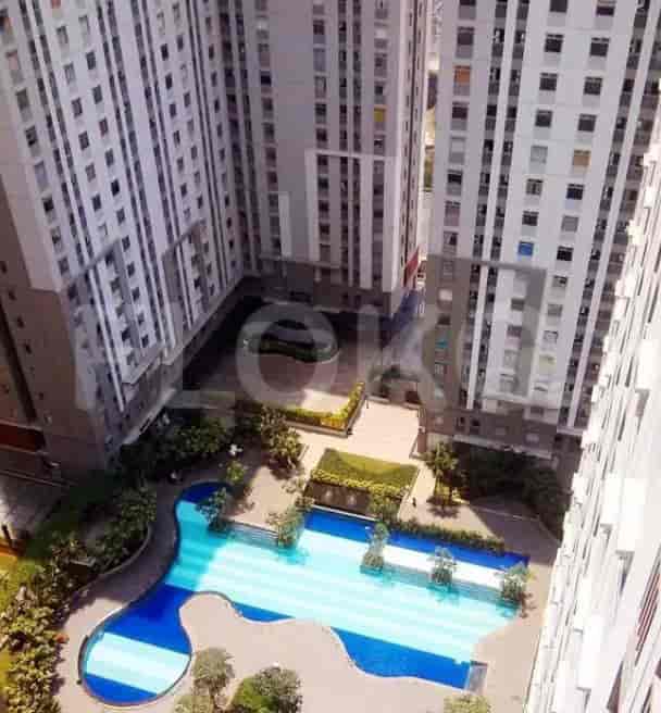An aerial view of an apartment complex with a pool.