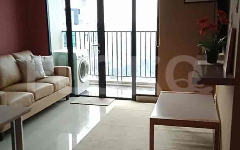 Living room with a sofa, balcony, and a washing machine.