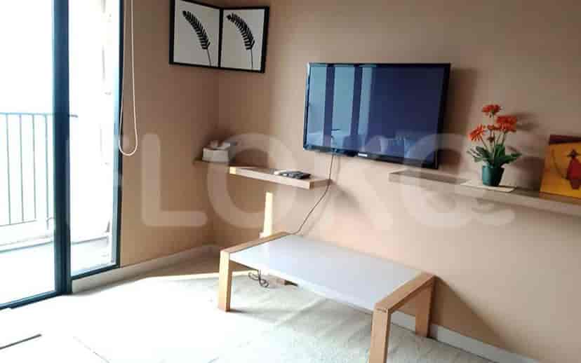 Living area with a smart TV and shelving.