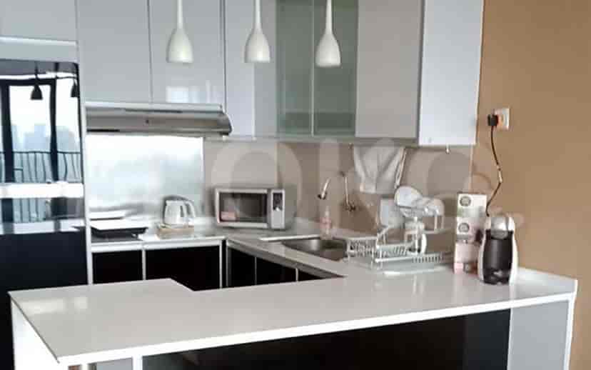 Modern kitchen with white cabinets and stainless steel appliances.