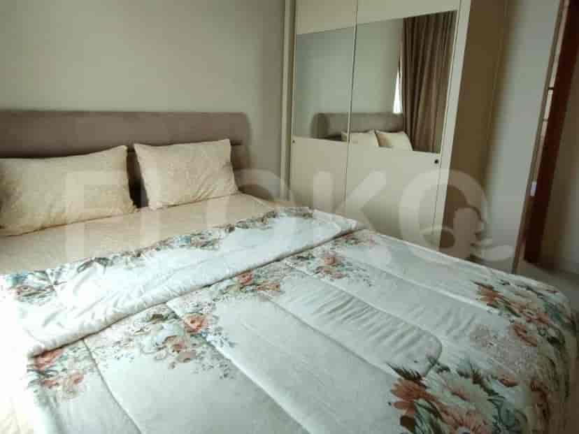 A bedroom featuring a bed with floral bedding and a large wardrobe.