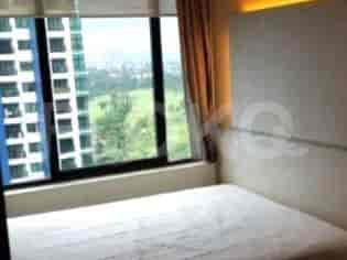 Bedroom with bed and large window.