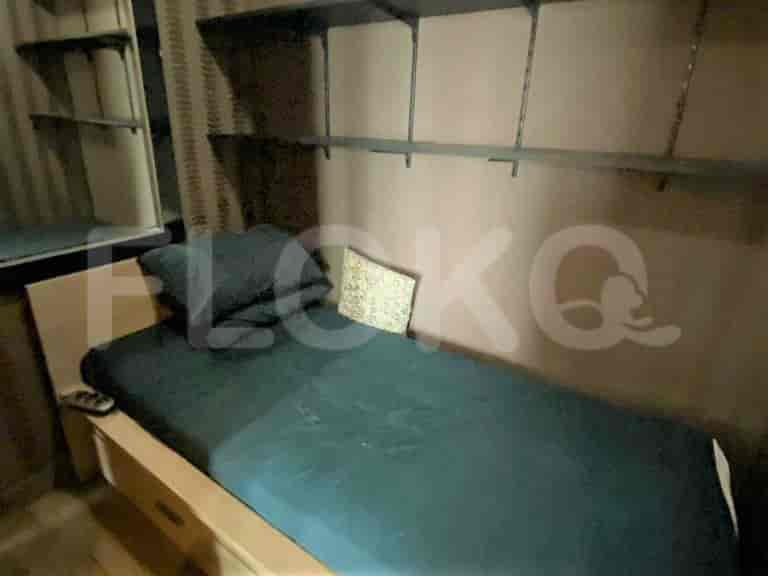 A bedroom with a single bed and shelves.