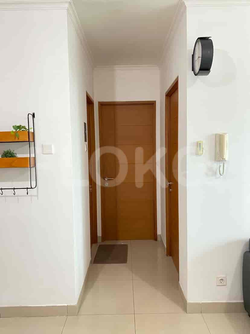 A hallway with three doors and a wall-mounted clock.