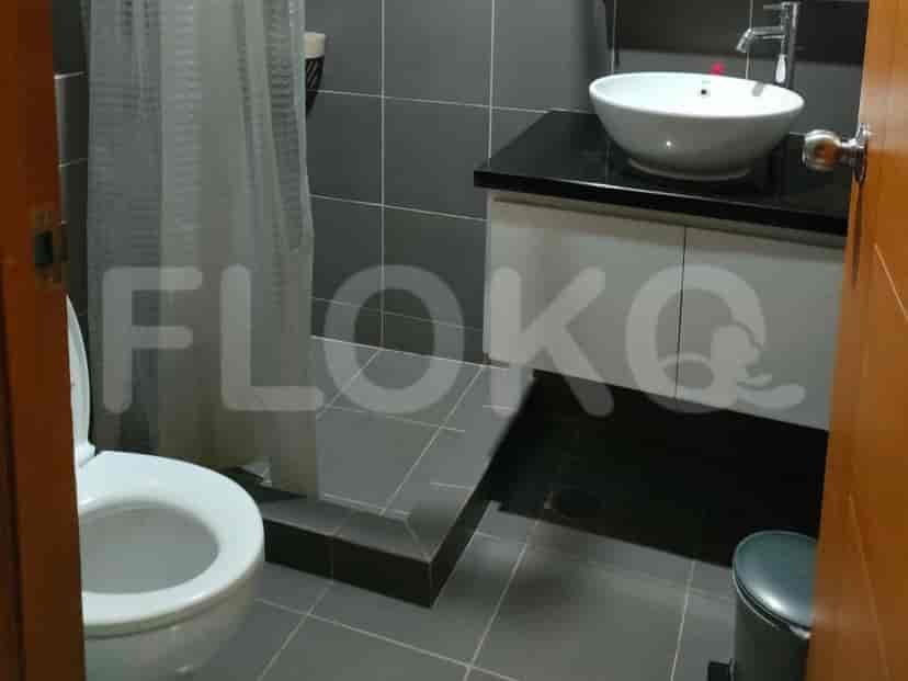 Modern bathroom with a sink, toilet, and shower curtain.