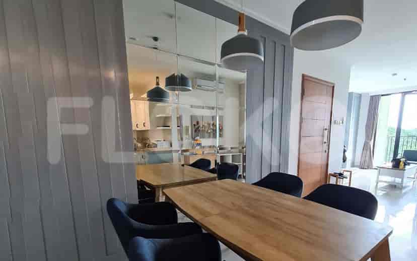 Dining area with a wooden dining table and hanging pendant lights.