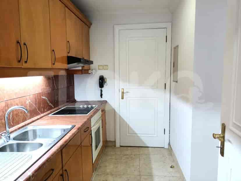 A kitchen with wooden cabinets and a stove.