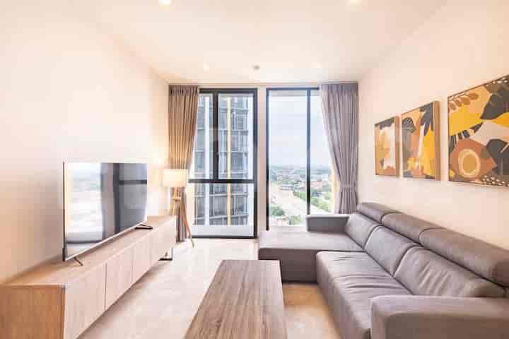 Modern living room with an L-shaped sofa, TV, and city view.