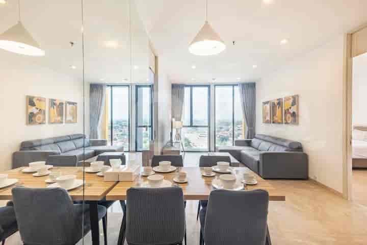 Dining area with a wooden table and mirrored wall.