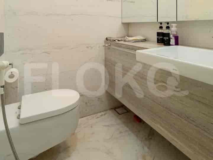 Modern bathroom with a marble counter and toilet.