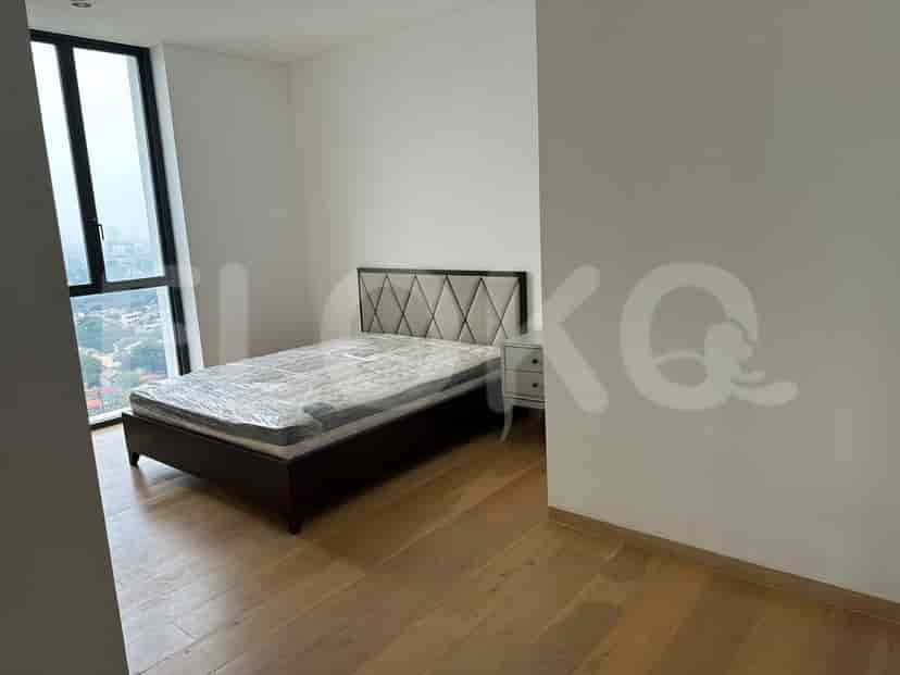 Bedroom featuring a bed, nightstand, and cityscape views.