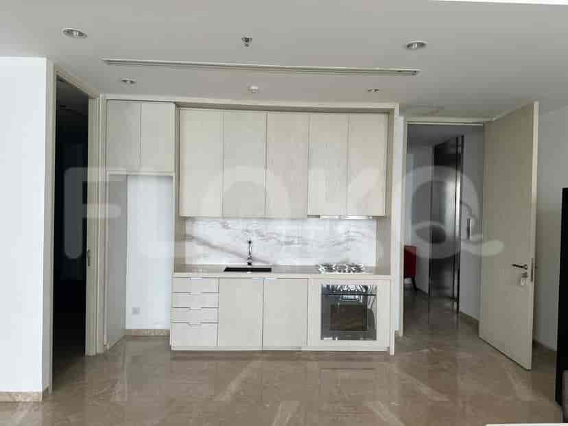 Modern, minimalist kitchen with light-colored cabinets and marble backsplash.