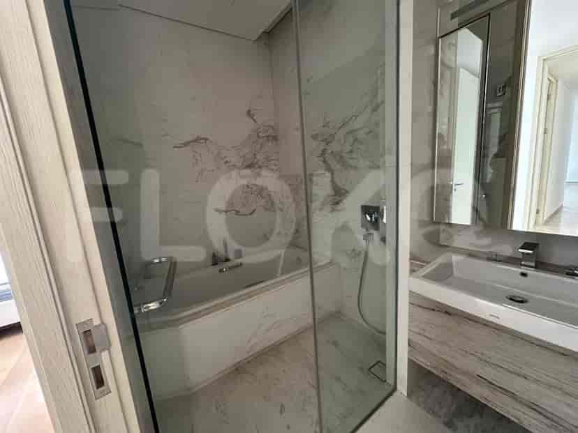 Elegant bathroom with a bathtub, glass shower enclosure, and marble accents.
