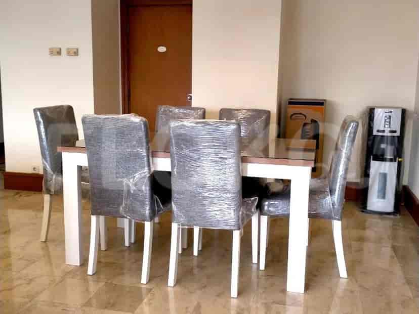 The dining area features a rectangular dining table with six chairs.