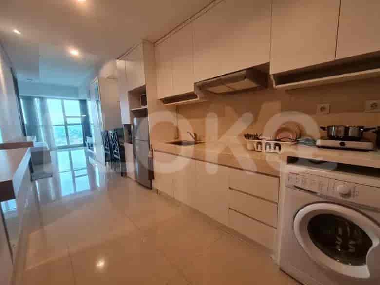 A modern kitchen with white cabinetry, a stainless steel refrigerator, and a washing machine.