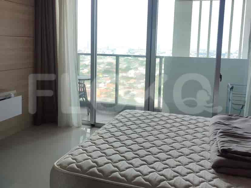 Bedroom with a bed, balcony access, and city view.