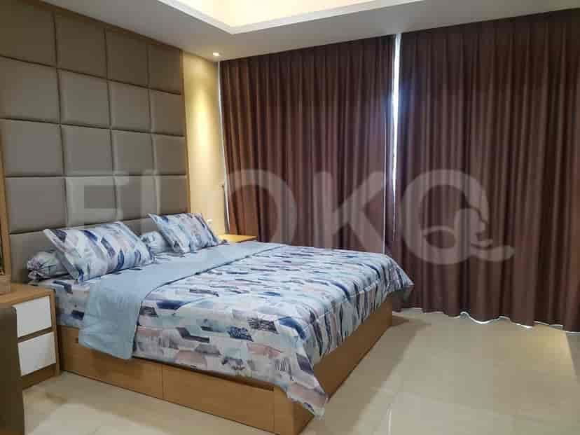 A bedroom with a bed, patterned duvet, and brown curtains, offering a cozy atmosphere.