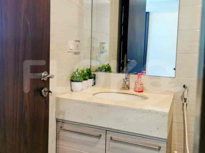 A modern bathroom with a sink and a large mirror.