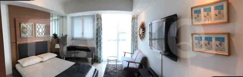 A panoramic view of the living room and bedroom, connected by design.