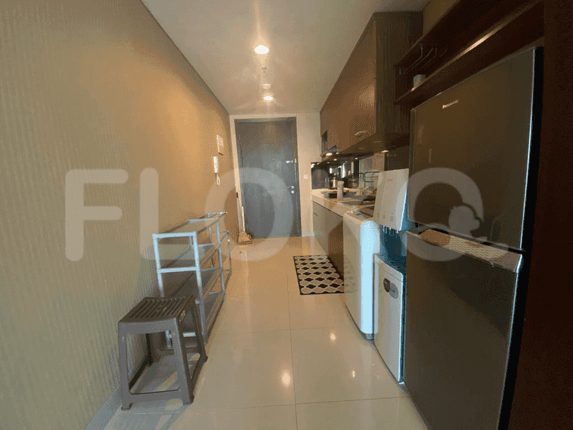 Kitchen and hallway with a fridge and washing machine.