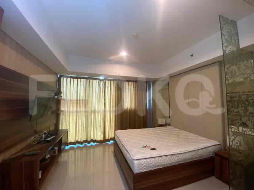 Another view of the bedroom with curtains and a wooden panel.