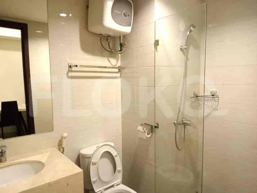 A modern bathroom with a shower and toilet.