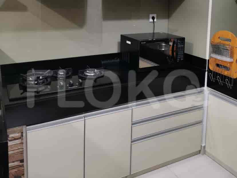 Another view of the kitchen showcasing the cooking area and appliances.