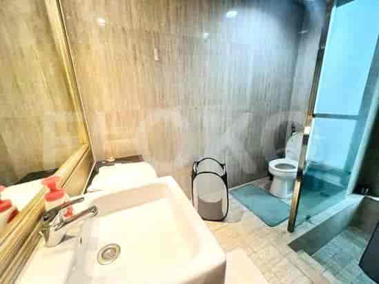 Modern bathroom with a sink, toilet, and a glass shower enclosure.