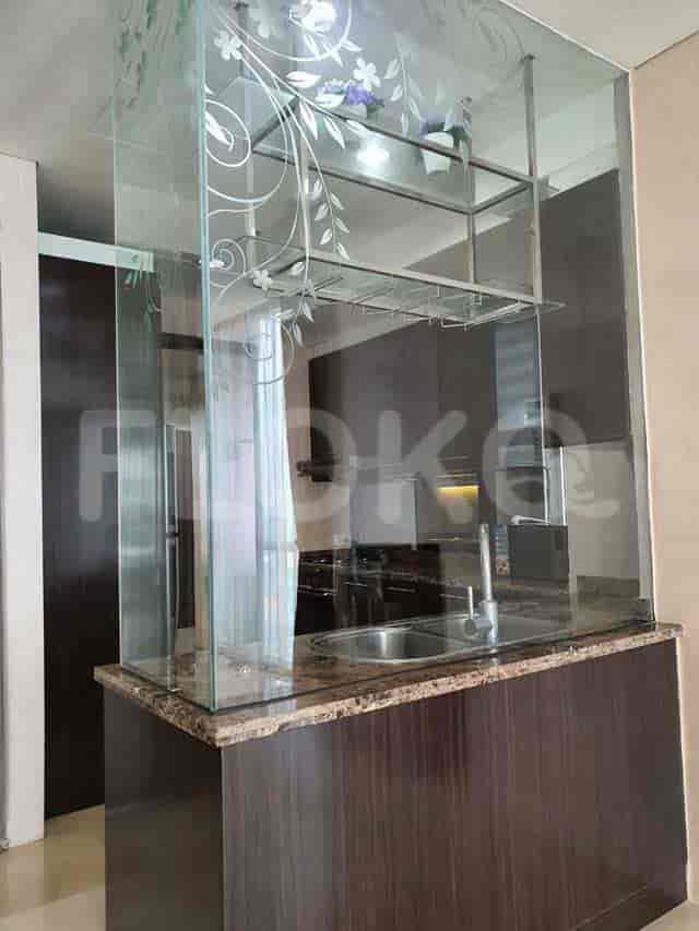 Kitchenette area with a sink and wine rack.