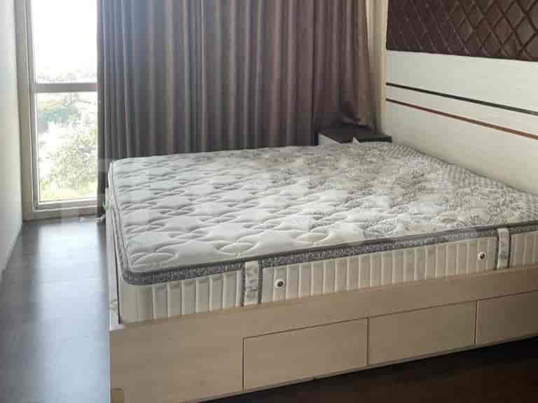 Bedroom featuring a bed with a floral-patterned mattress and dark curtains.