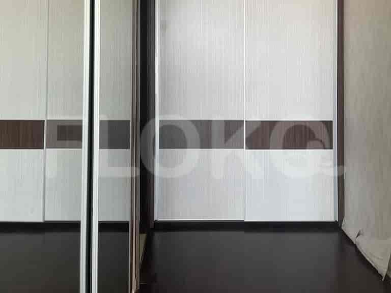 Sliding door closet with a mirrored door.