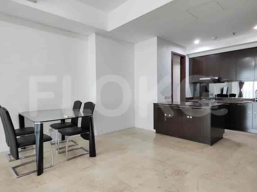 Open-plan dining and kitchen area with a dining table and kitchen island.