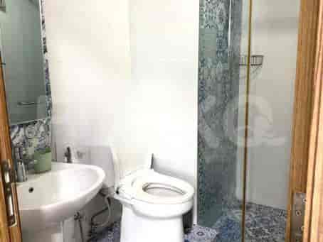 A bathroom with a toilet, a sink, and a shower.