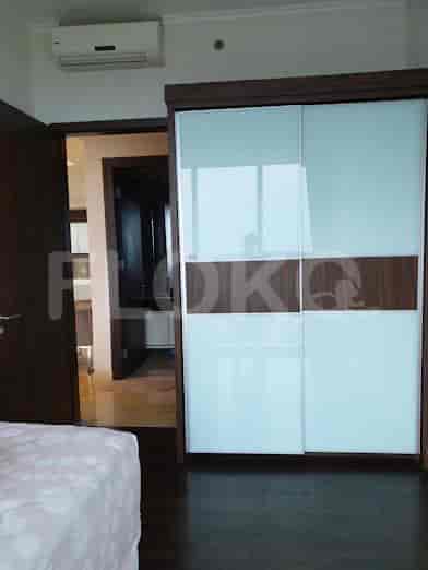Bedroom featuring a sliding closet and a glimpse into the kitchen.