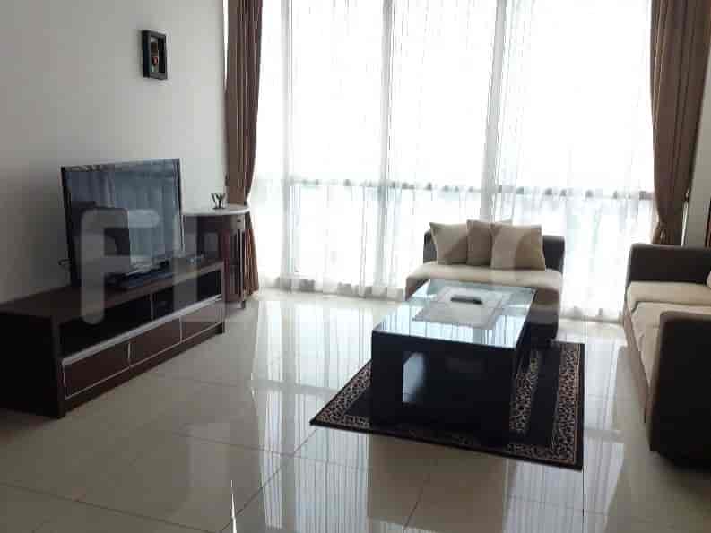 A living room with a TV, sofa, and coffee table, showcasing a modern interior.