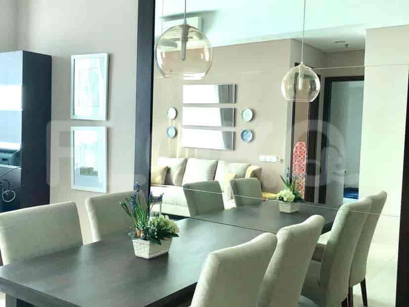 Dining area with a large mirror and round pendant lights.