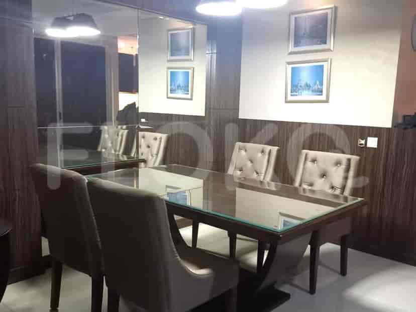 Dining area with a table, chairs, and wall decor.