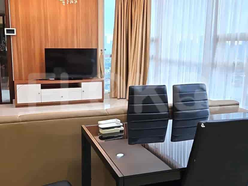Dining area with a table and chairs, and a TV.