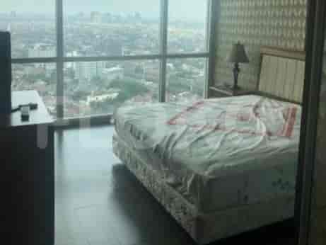Bedroom with a bed, city view, and bedside table.