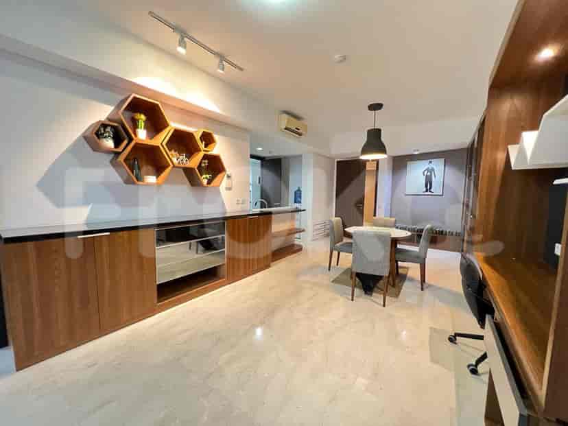 Dining area featuring a round table, chairs, and a side cabinet.