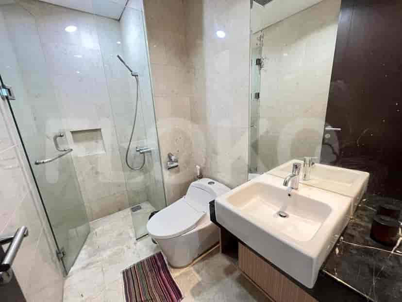 A modern bathroom with a glass-enclosed shower.