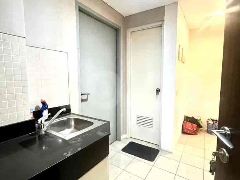Laundry room with a sink and storage space.