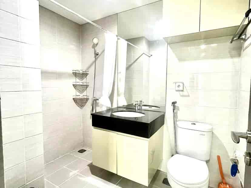 Modern bathroom with a sink, shower, and mirror.
