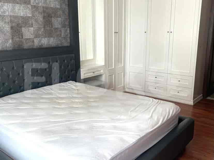 Bedroom with a bed, wardrobe, and mirror.