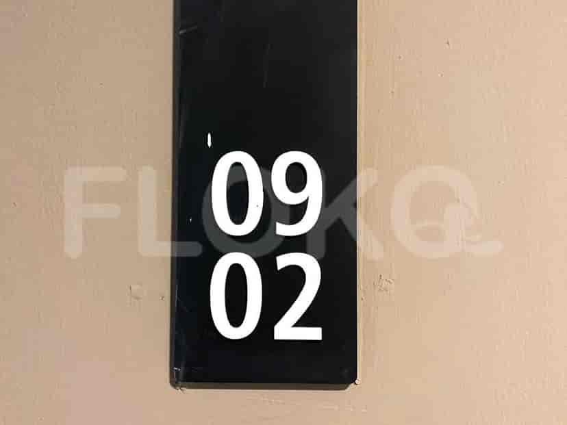Apartment number displayed on a wall.
